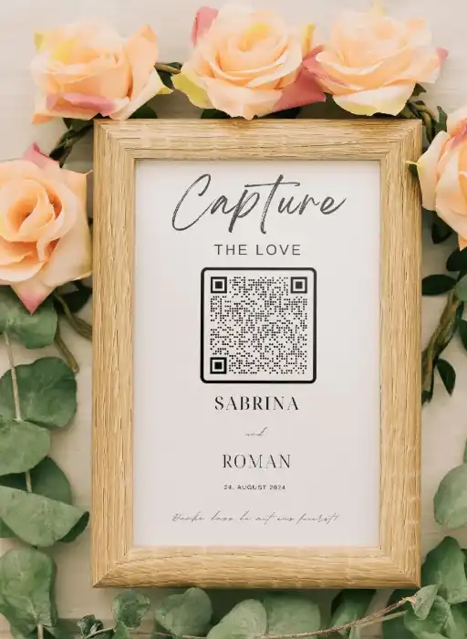 Wedding guest book framed with QR code to collect wedding photos, surrounded by roses.