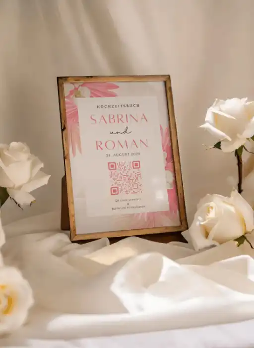 Framed wedding QR code for guest book to collect wedding photos, surrounded by white roses.